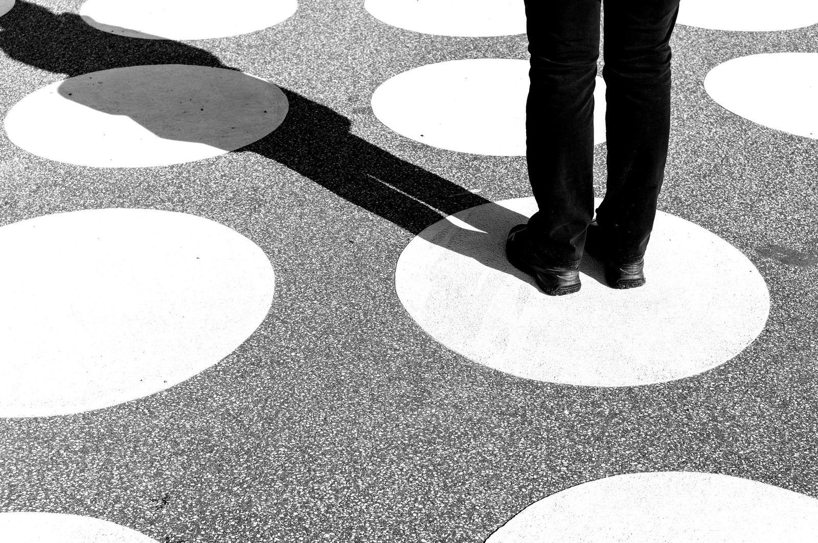 Person standing, casting shadow