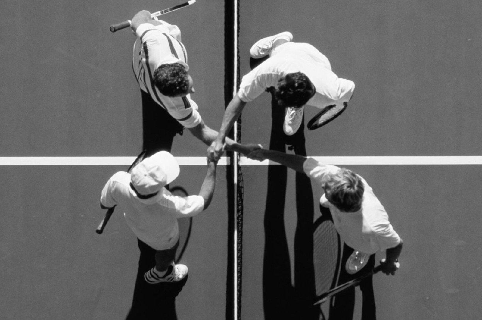 Aerial view of men shaking hands across tennis net