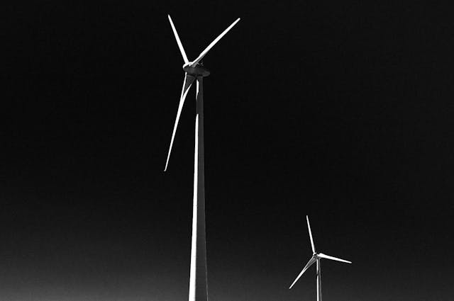 A wind turbine in the distance, with a black backdrop