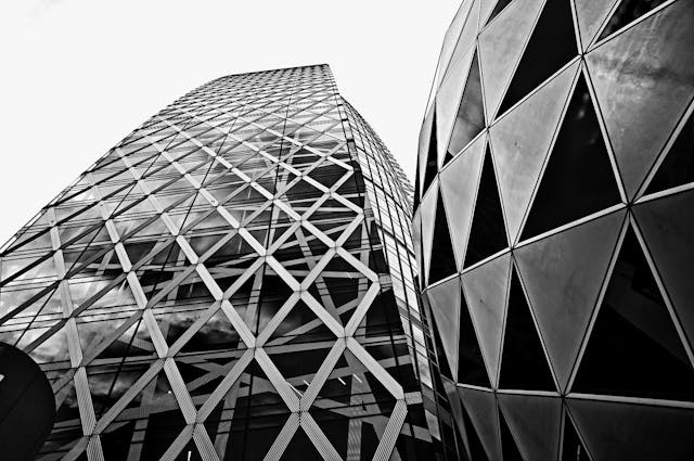 Black and white image of two geometric pattern office buildings