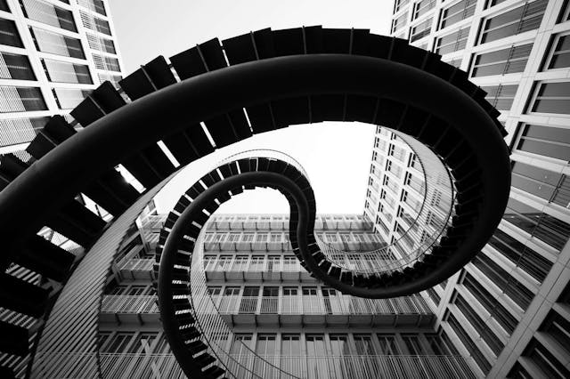 spiral stairs in front of an modern office building