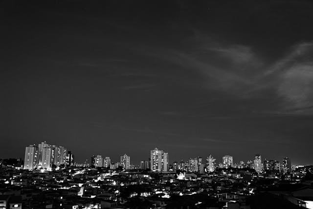 Buildings on cityscape at night on black and white