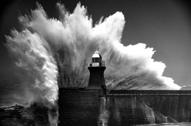 Waves crashing against a lighthouse