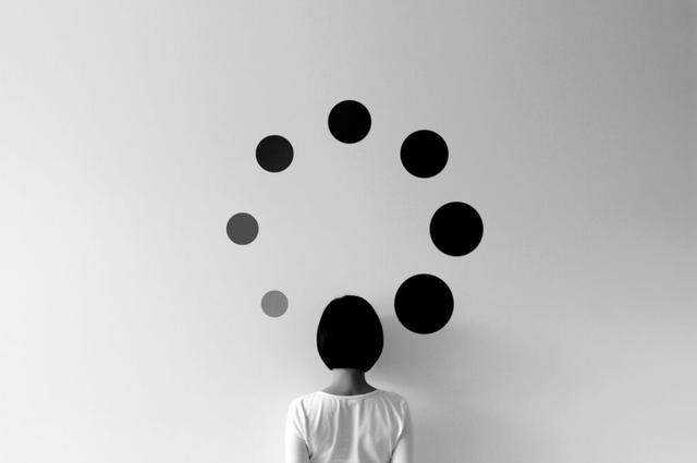 A woman looking at dots on the wall