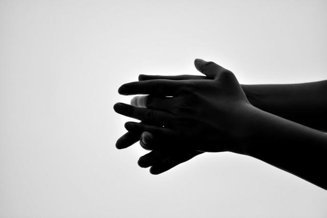 Close up of flamenco dancer hands making rhythm by claping in black and white.