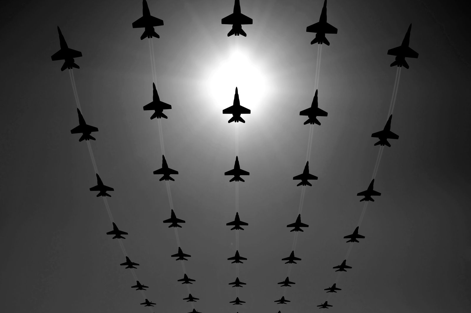 Man walking through a door standing alone in a vast reflective landscape, suggesting transition or new beginnings.